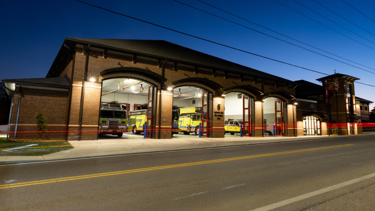 Ashland City Fire Department station illuminated at dusk with an emergency vehicle in the open bay