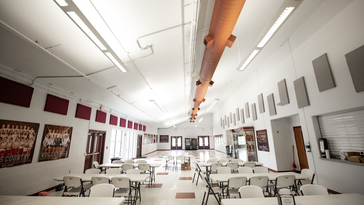 Clarksville Christian School cafeteria and student common area with tables and athletic displays