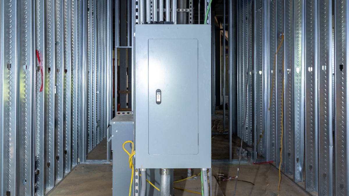Commercial electrical panel installed within unfinished metal wall framing