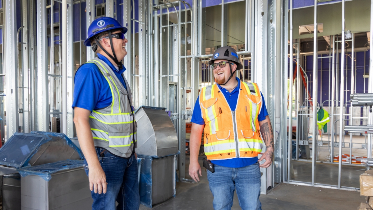Commercial electrical project managers inside a building under construction