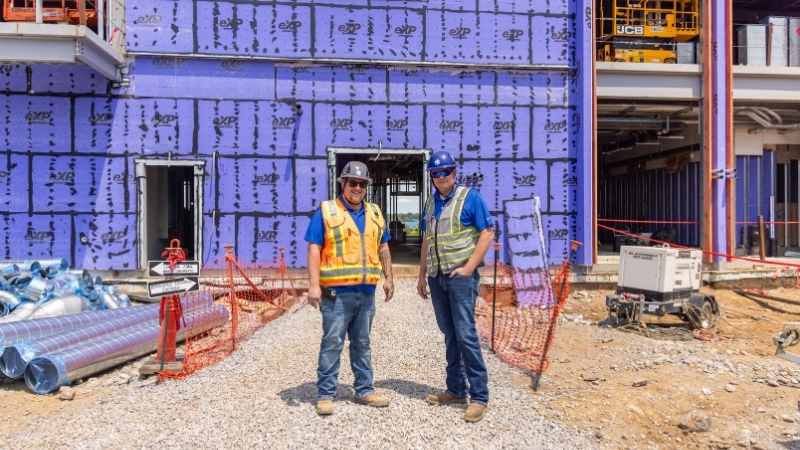 Commercial Electricians Standing In Front of Project in Progress