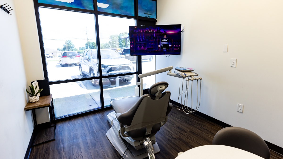 Ironwood Dental exam room with patient chair, dental equipment, television and large exterior window