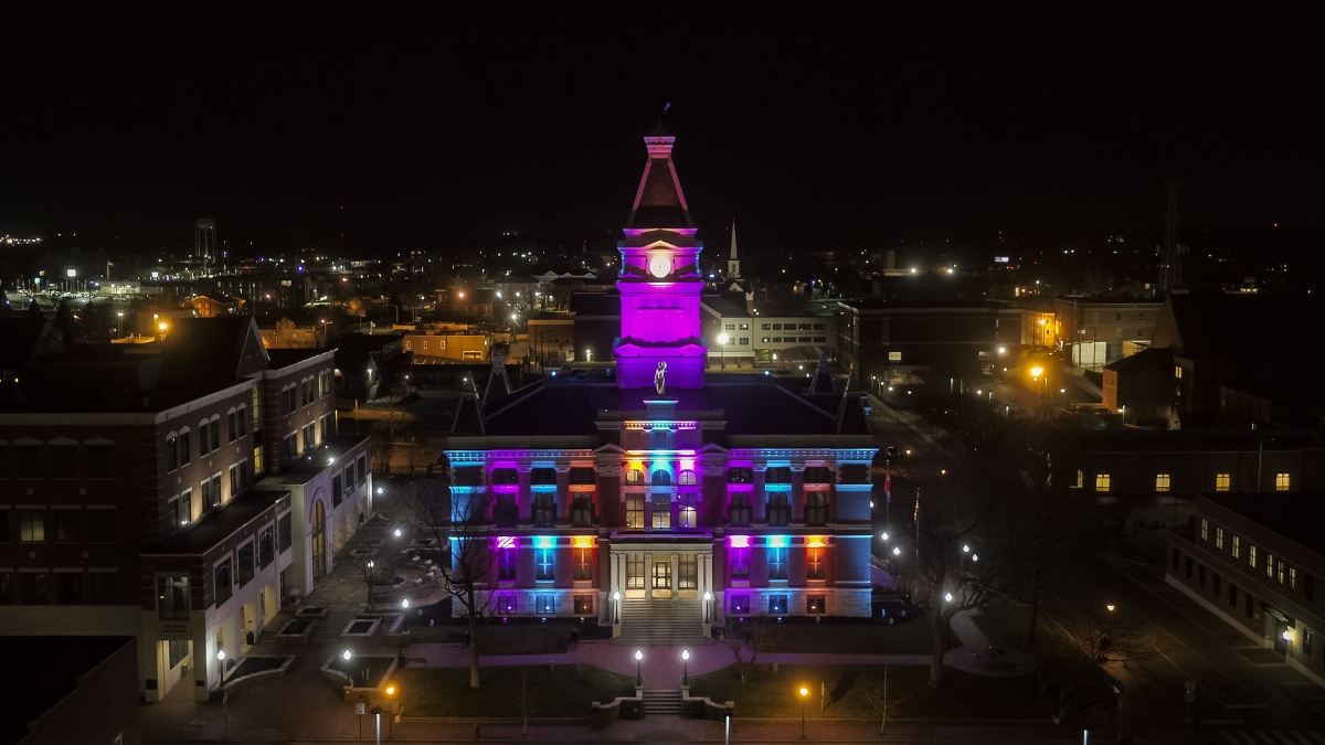 Montgomery County Courthouse illuminated with blue, purple and orange lights at night