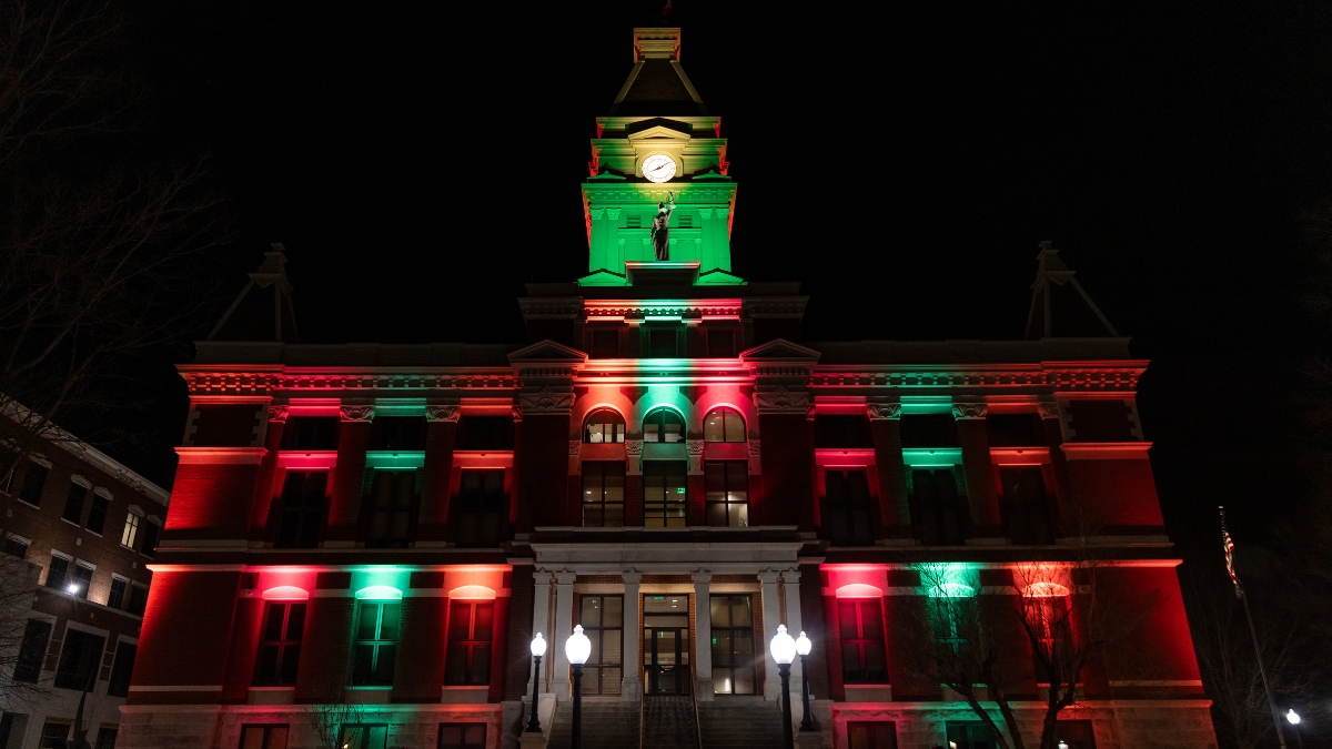 Montgomery County Courthouse illuminated with red and green Christmas lights