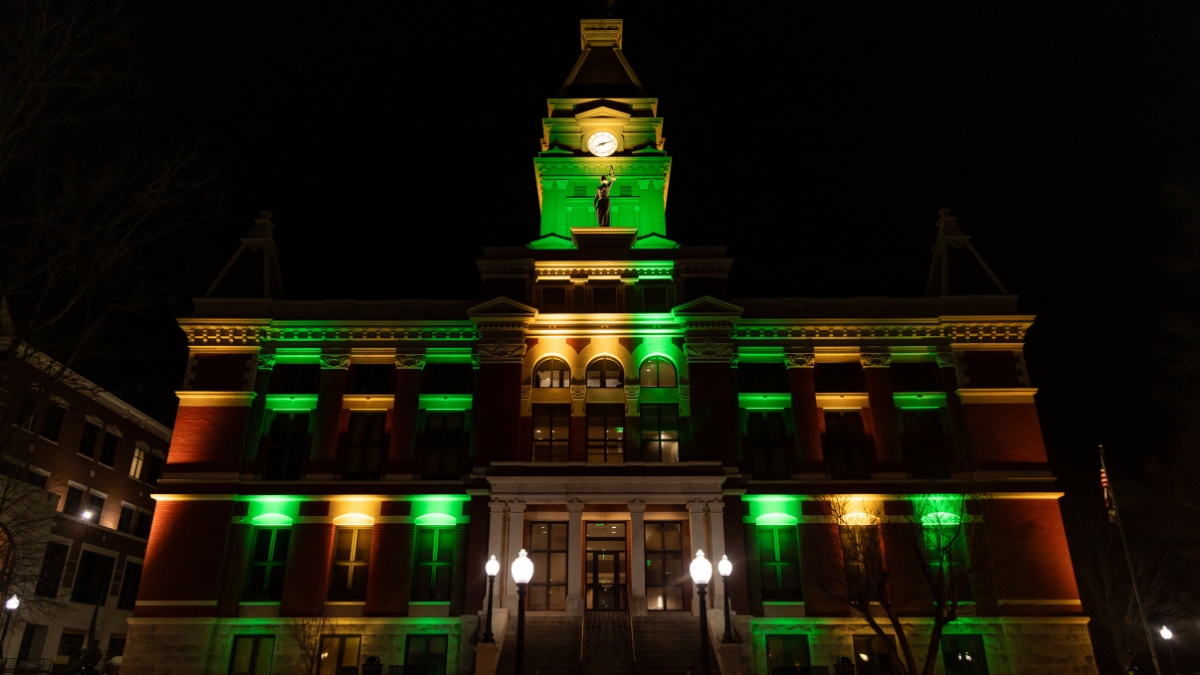 Montgomery County Courthouse illuminated with green and warm white lights at night