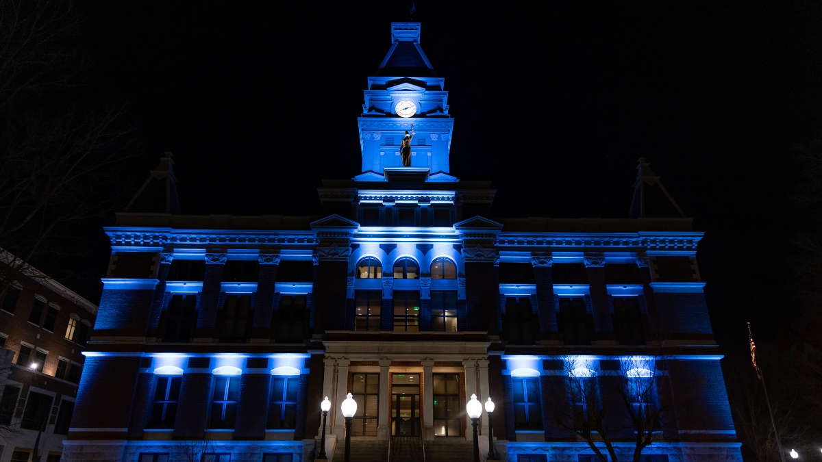 Montgomery County Courthouse illuminated with blue and white lights at night