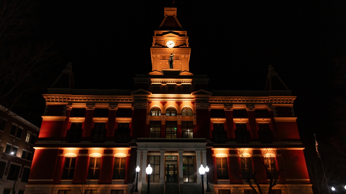 Montgomery County Courthouse illuminated with warm orange lights at night