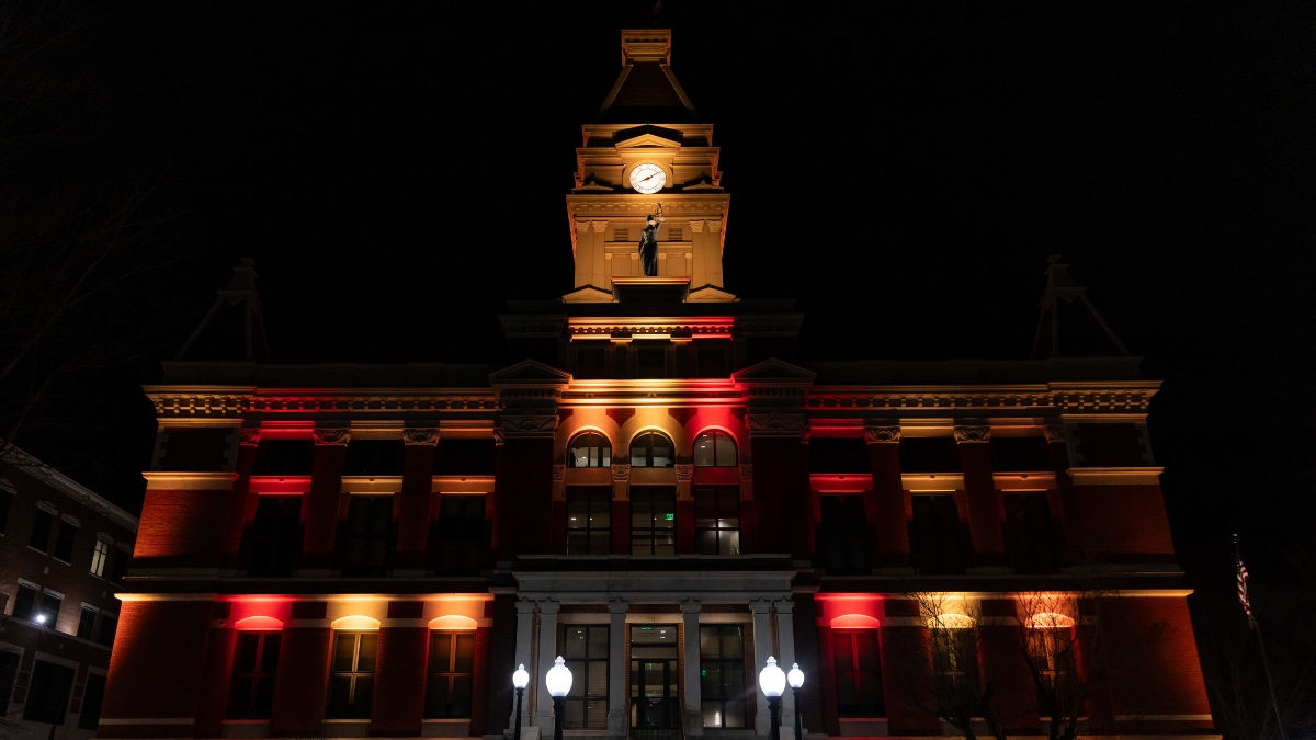 Montgomery County Courthouse illuminated with red, orange and gold lights at night