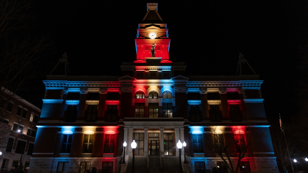 Close view of the Montgomery County Courthouse illuminated in patriotic red, white and blue