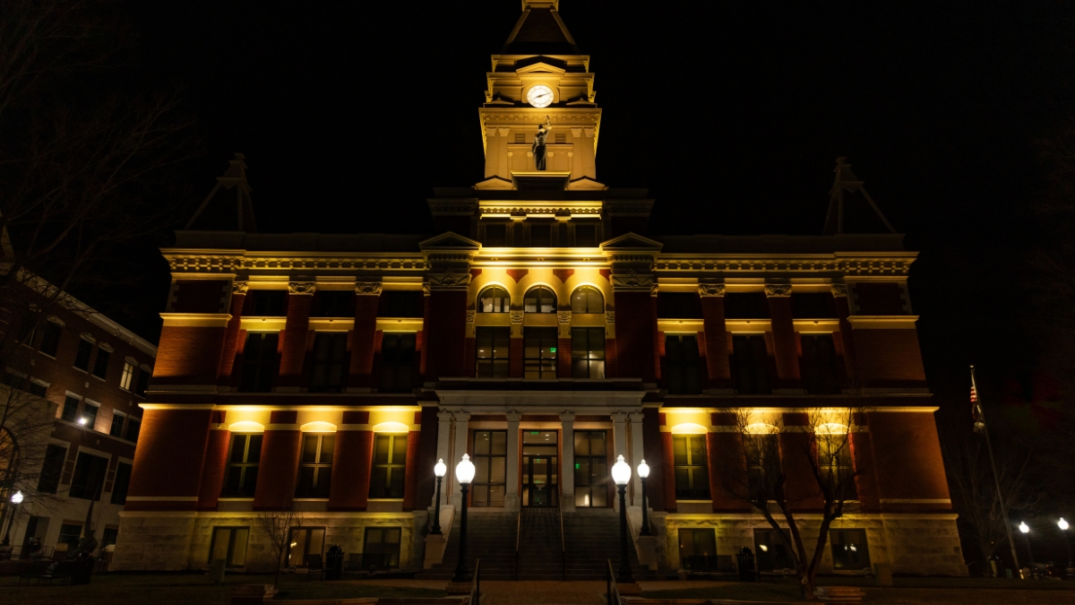 Montgomery County Courthouse illuminated with warm yellow lights at night