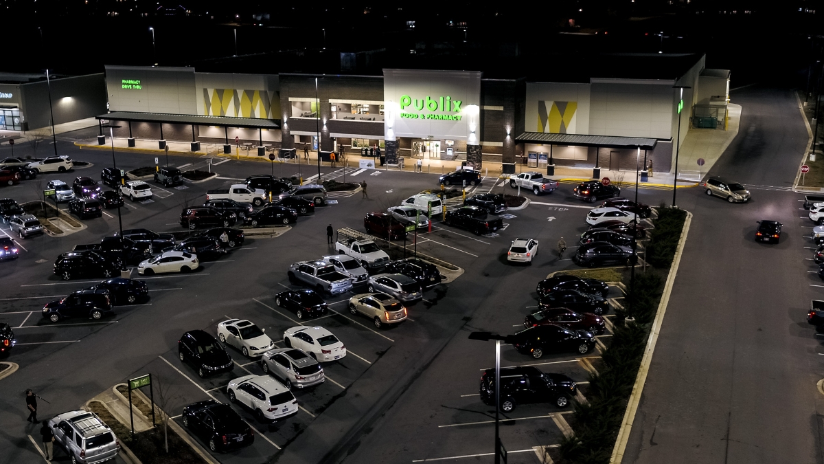 Aerial view of a Publix grocery store and illuminated parking lot at night
