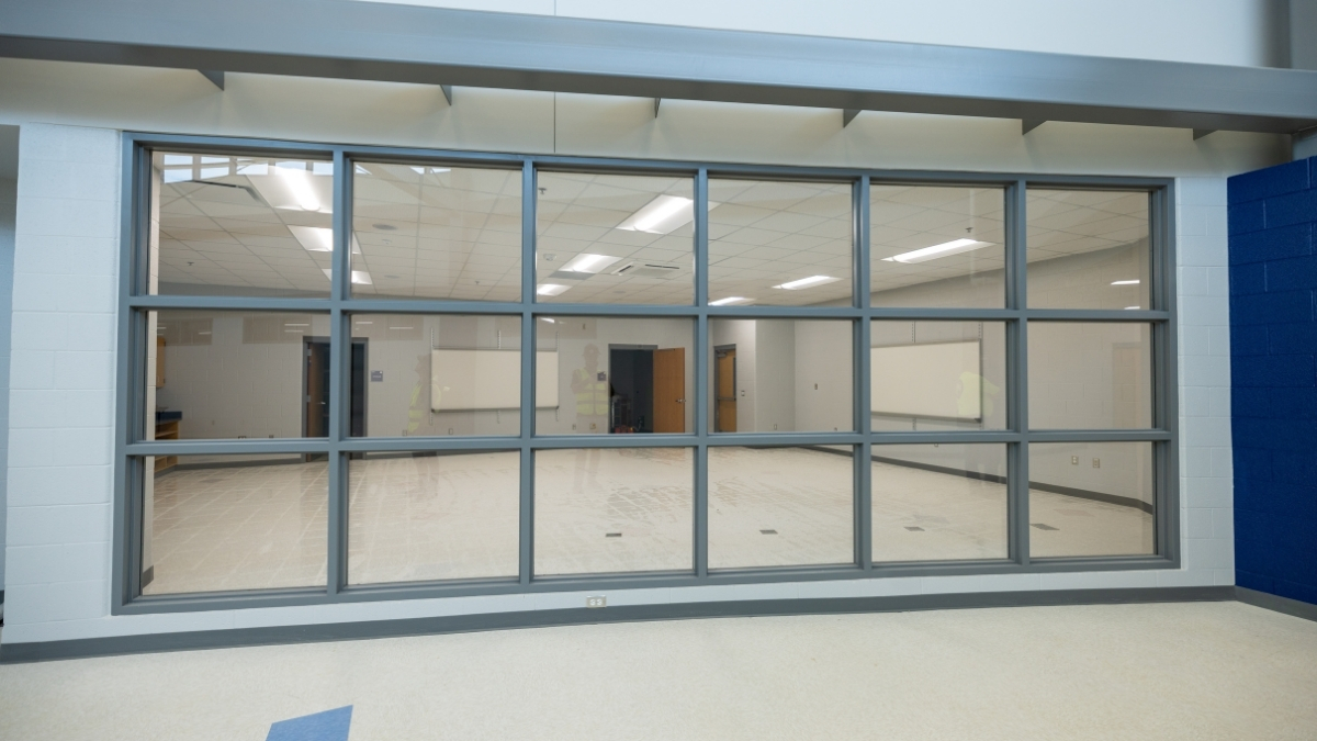 School classroom viewed through a large interior glass wall