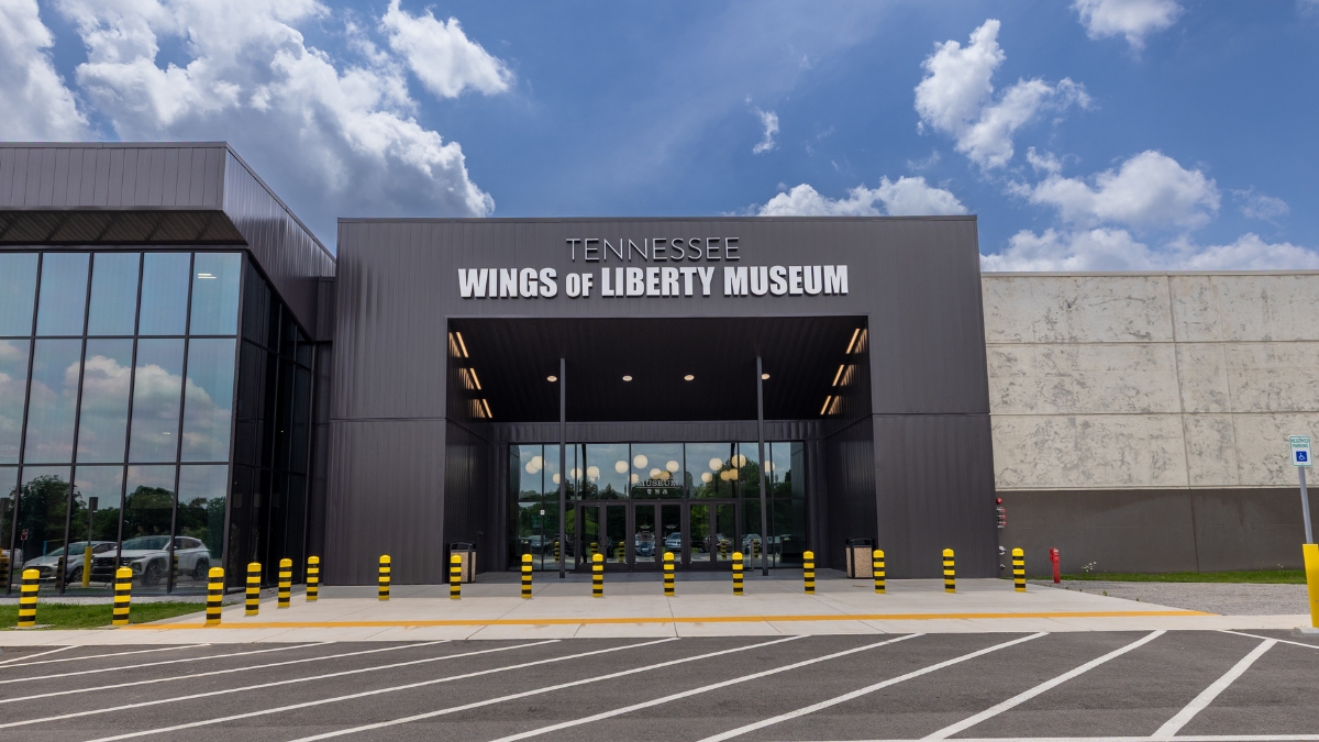 Main entrance to the Tennessee Wings of Liberty Museum under a blue sky