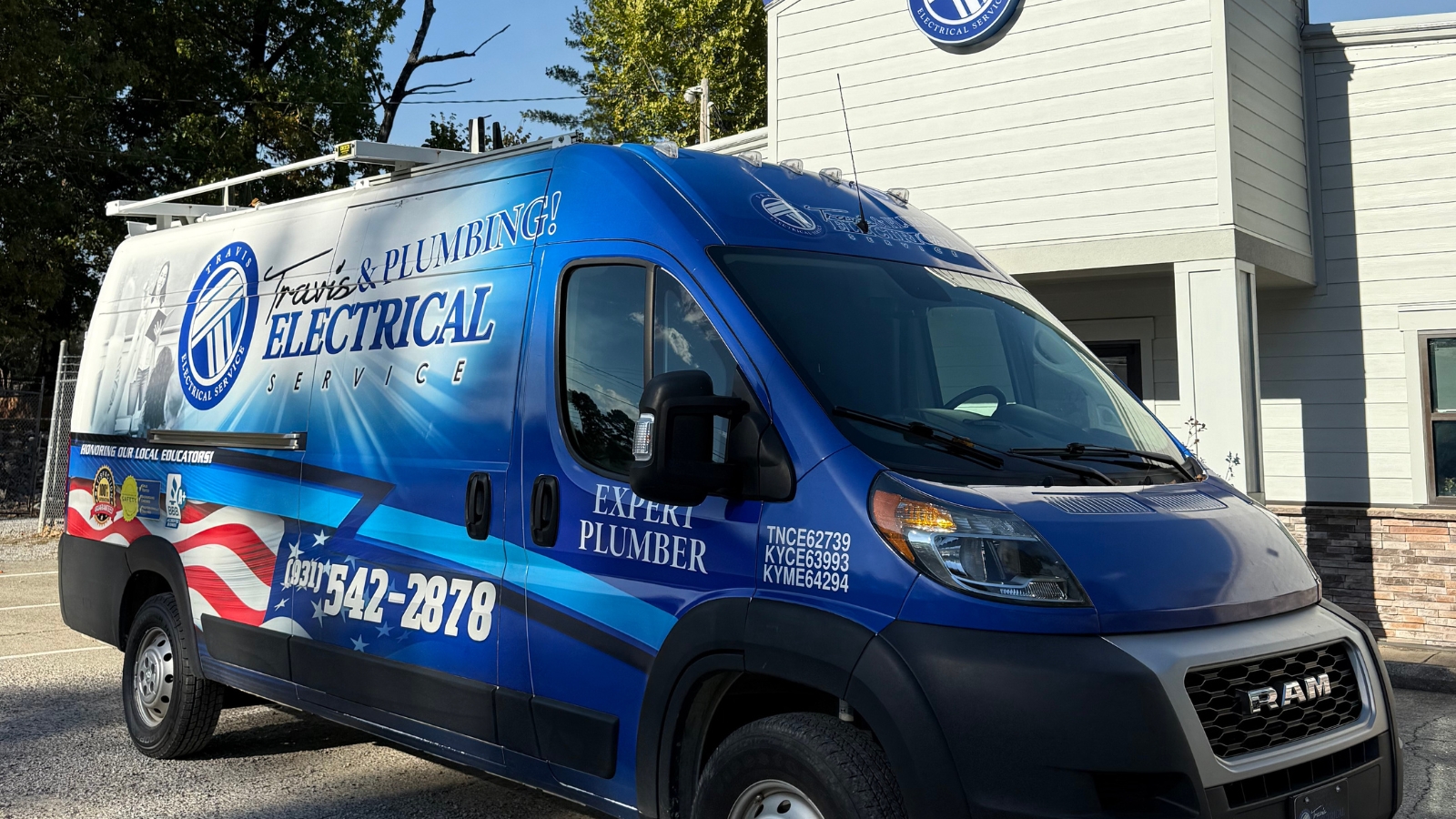 travis electrical service van parked in front of office building