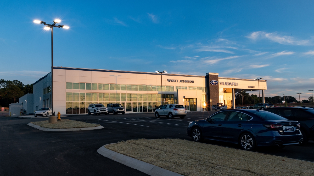 Wyatt Johnson Subaru dealership exterior at dusk with vehicles parked in front