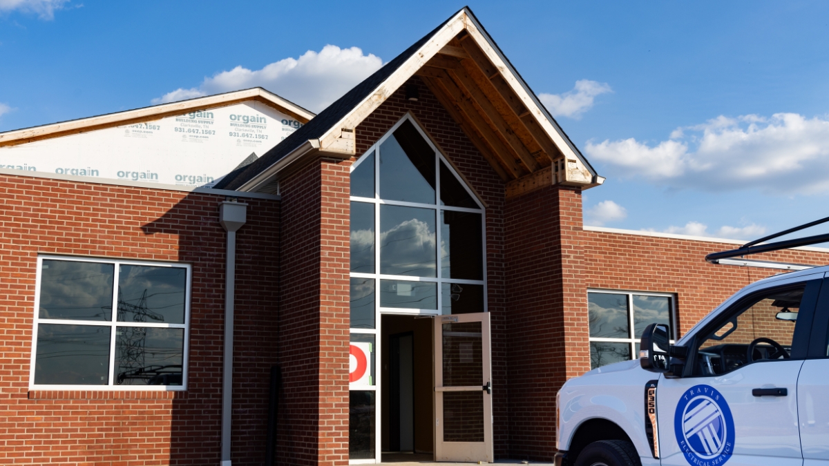 Youth activity center renovation with brick exterior and Travis Electrical Service truck